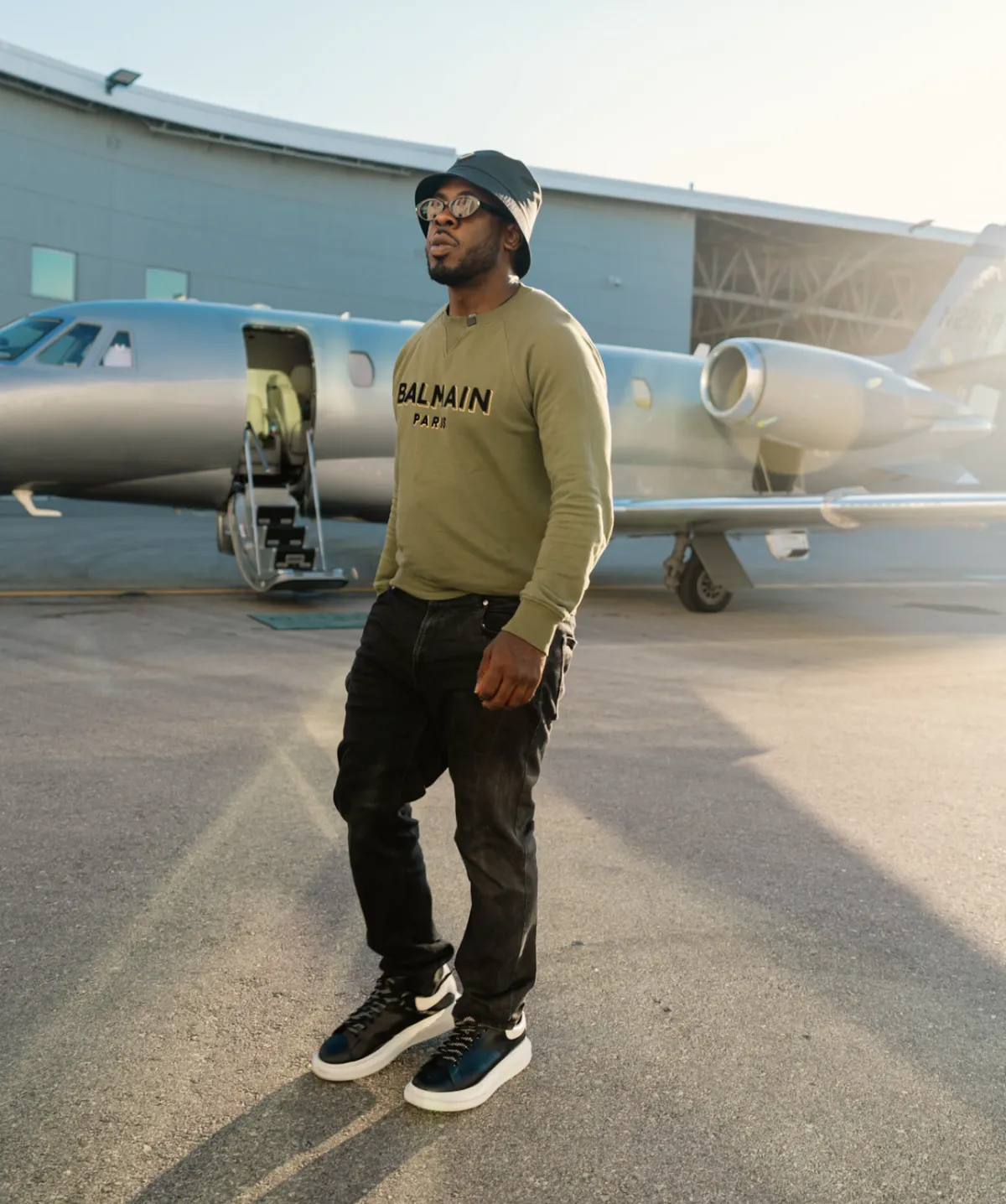 Kel on the tarmac in front of a private jet