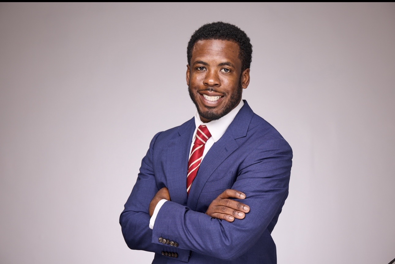 Kel — RentalCarKing — portrait in a navy suit